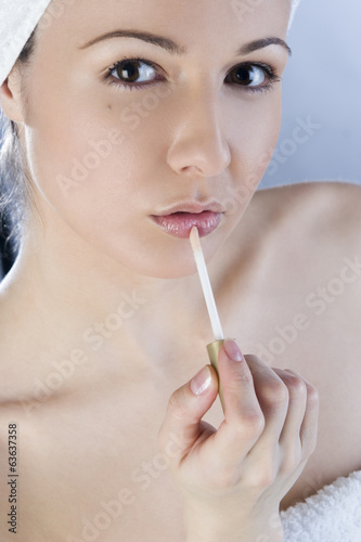 Girl applying lipstick