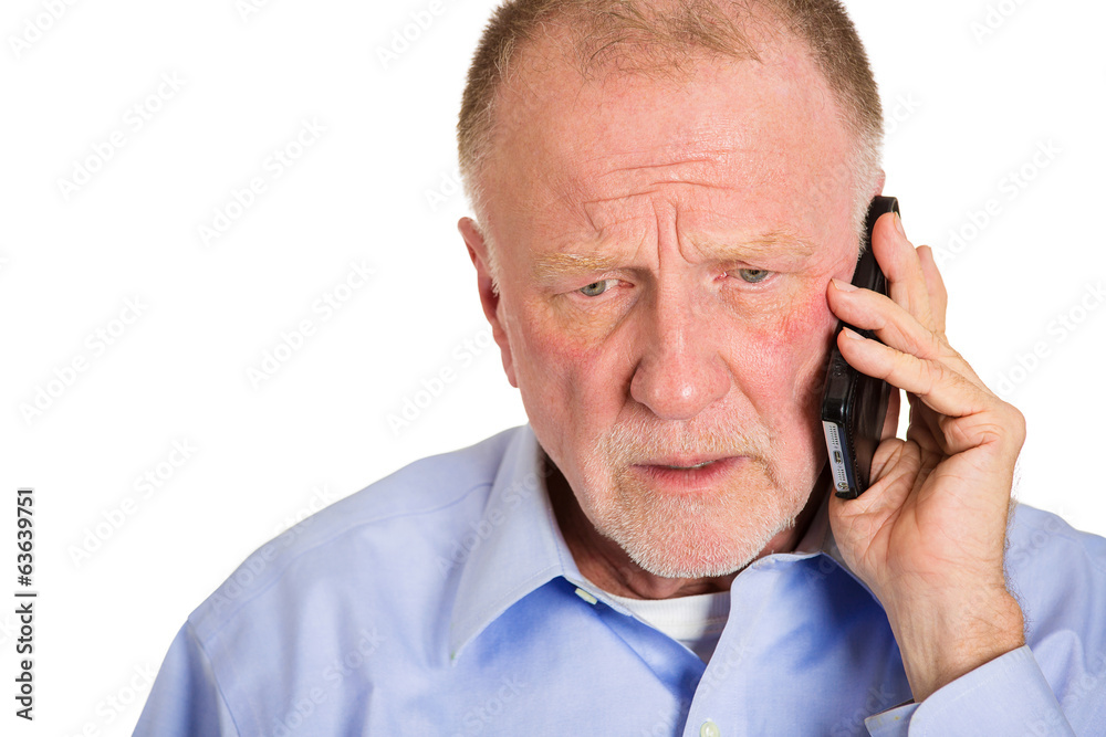 Depressed sad old man receiving bad news on phone Depressed sad old man receiving bad news on phone