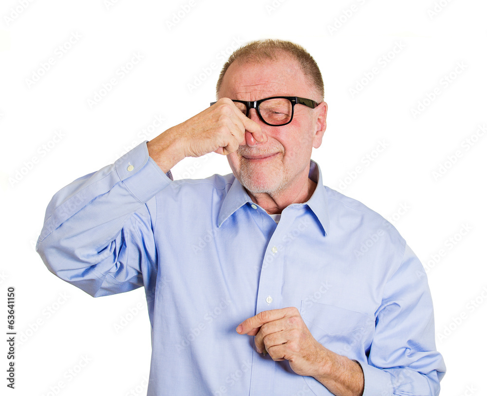 Something stinks. Portrait older man pinching his nose Something stinks. Portrait older man pinching his nose