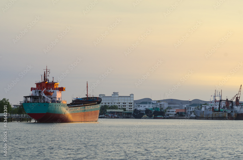 Cargo ship in the harbor at sunset, Thailand Cargo ship in the harbor at sunset, Thailand