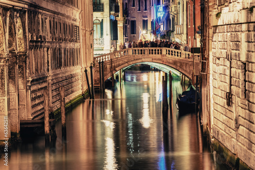 VENICE, ITALY - MAR 23, 2014: Bridge of Sighs at night with tour