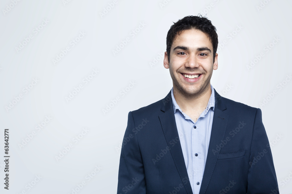 Confident business man smiling on grey background Confident business man smiling on grey background
