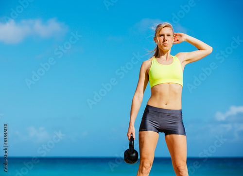 Fototapeta Naklejka Na Ścianę i Meble -  Attractive Athletic Woman Doing Kettle Bell Workout