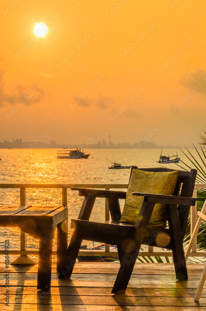 Wood chair sunset on the beach