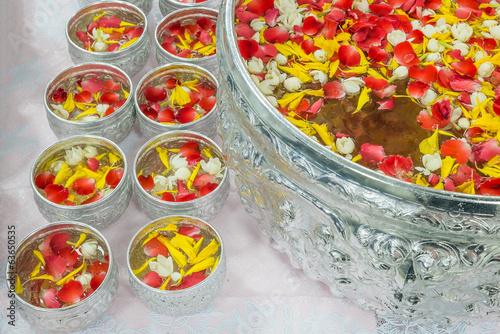 Water with jusmine and roses corolla in bowl for Songkran festiv