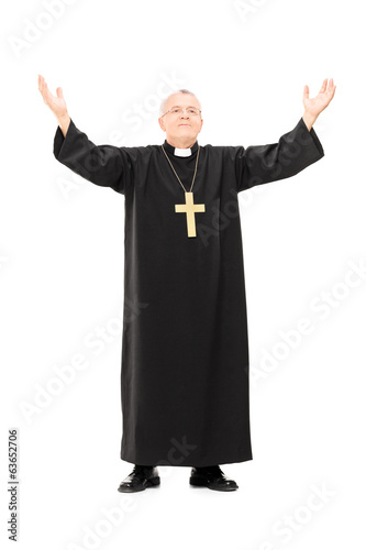 Mature priest with his hands in the air