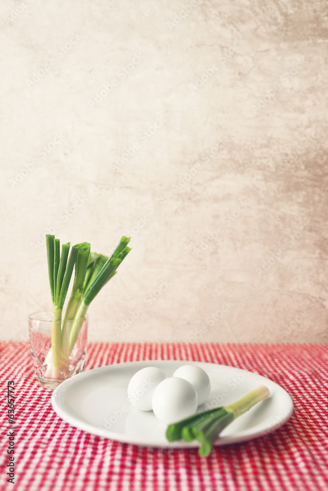 Boiled chicken eggs and fresh spring onion for breakfast