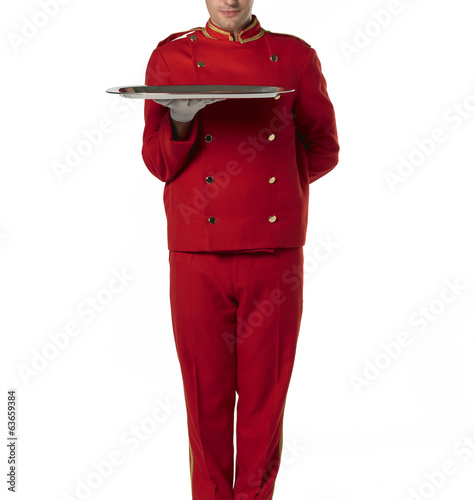 Bellboy with tray and red suit. photo
