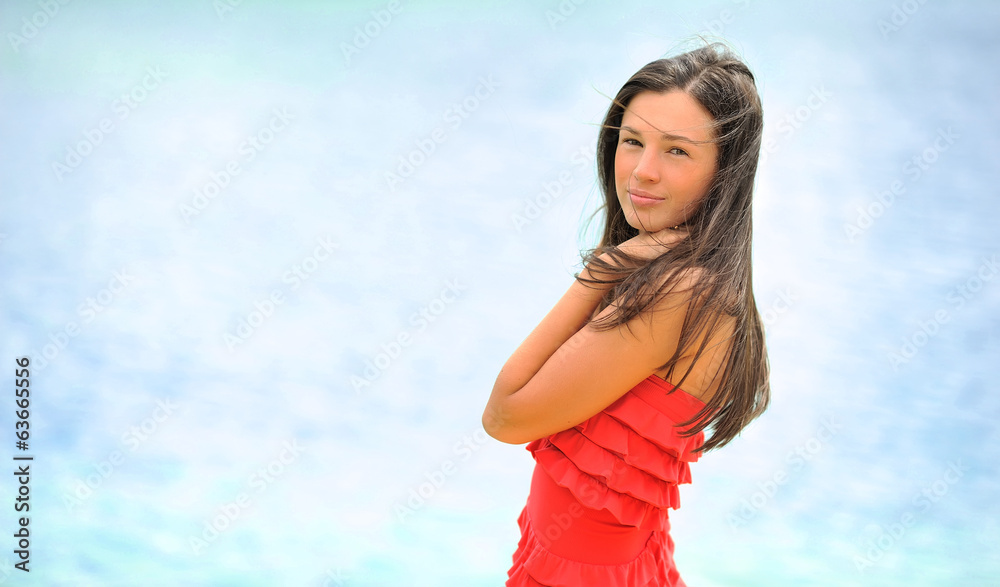 Attractive young woman posing over sea background
