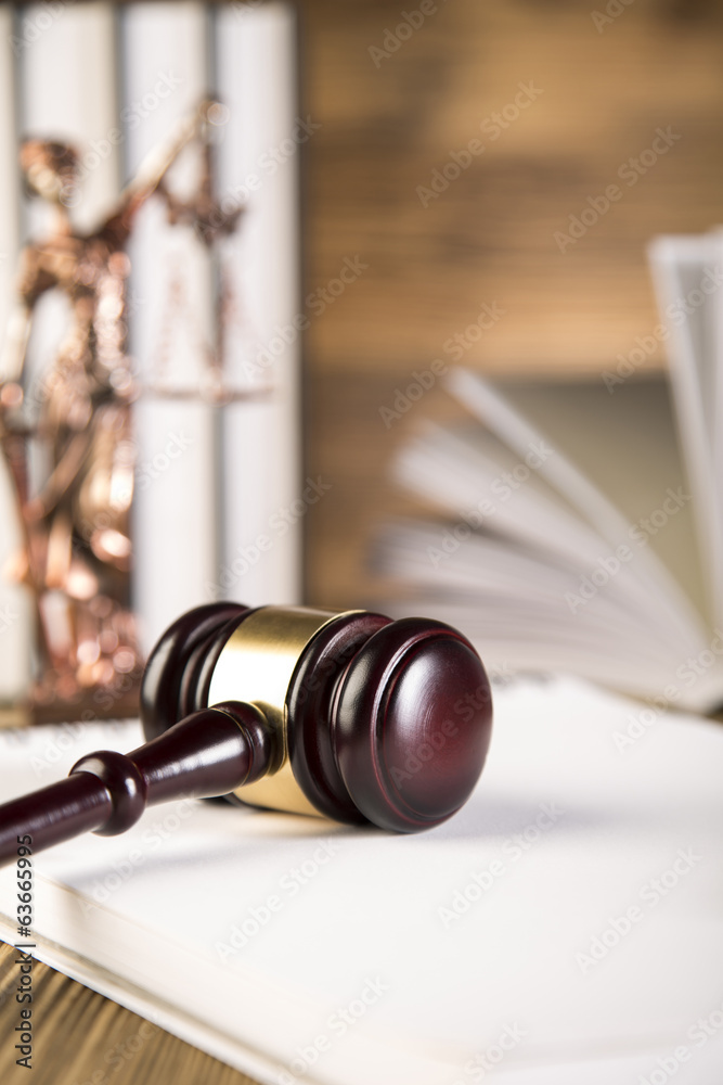 Lady of justice, wooden & gold gavel and books on wooden table