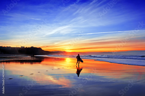 surfer in beach at sunset