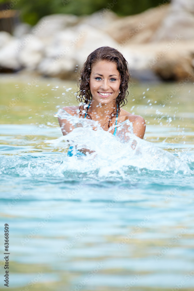 Sexy  bikini model splashing water