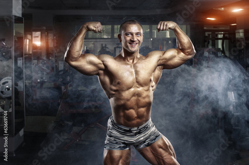 Bodybuilder man posing in the gym