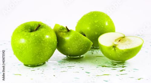 Green apples with waterdrops on table