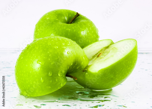 Green apples with waterdrops on table