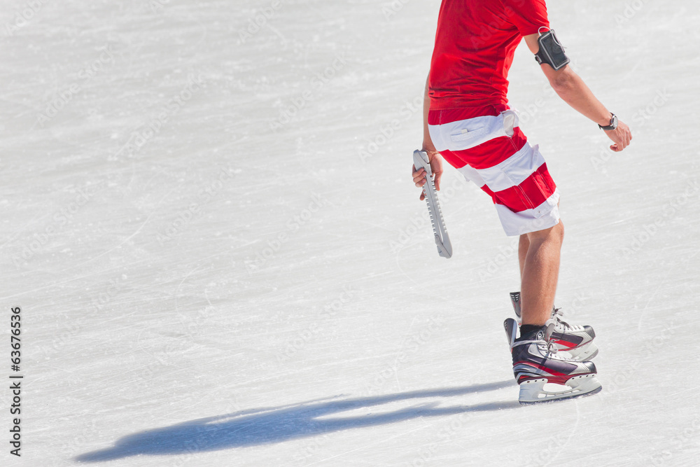Naklejka premium Young boy at the ice rink outdoor