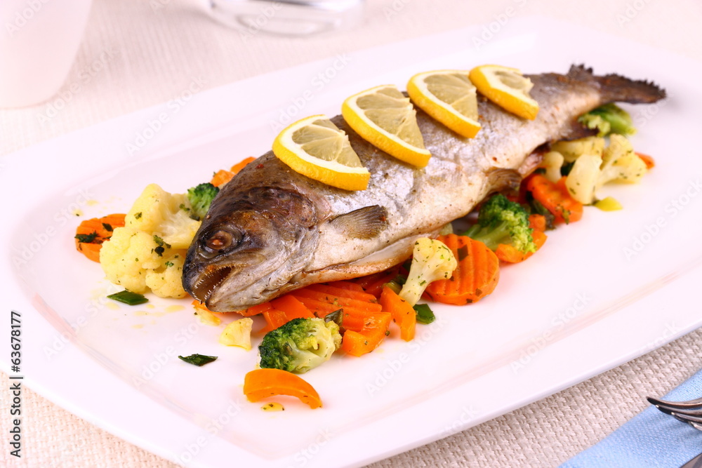 Grilled whole trout, vegetables and lemon Grilled whole trout, vegetables and lemon