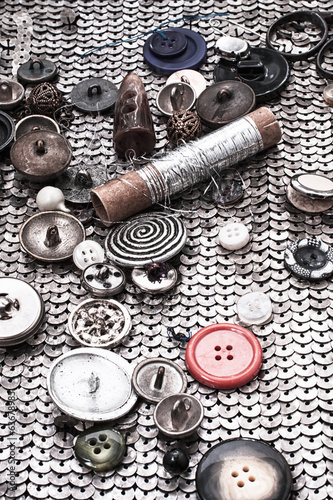 different buttons and zipper on the background of sewing tool