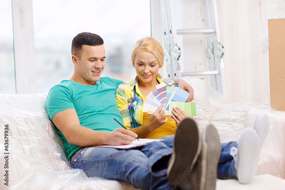 couple looking at color samples in new home couple looking at color samples in new home