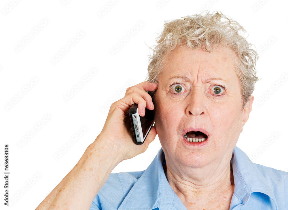 Old shocked lady receiving bad news on mobile phone Old shocked lady receiving bad news on mobile phone