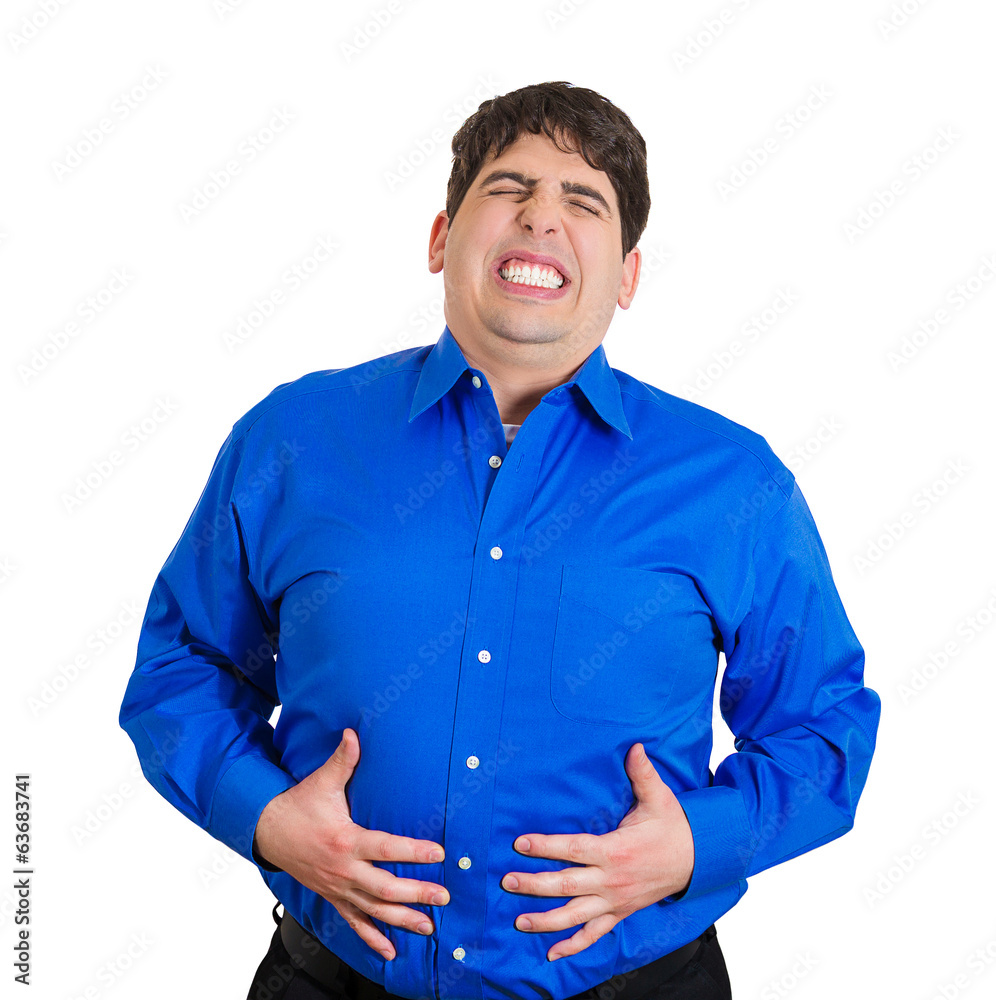 Young man with severe stomach pain hands on belly Young man with severe stomach pain hands on belly