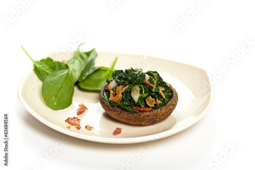 Stuffed mushroom with spinach and bacon. Selective focus. Macro.