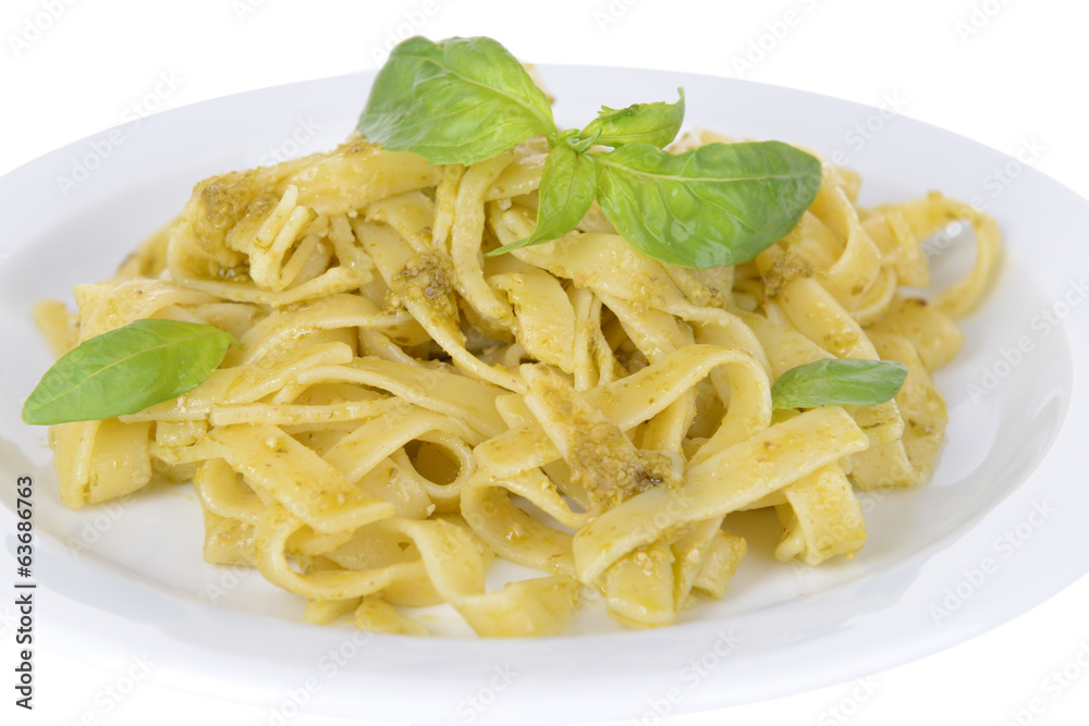 Delicious pasta with pesto on plate close-up Delicious pasta with pesto on plate close-up