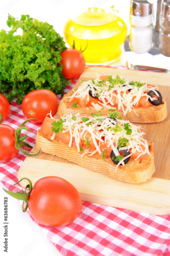 Delicious bruschetta with tomatoes on cutting board close-up Delicious bruschetta with tomatoes on cutting board close-up