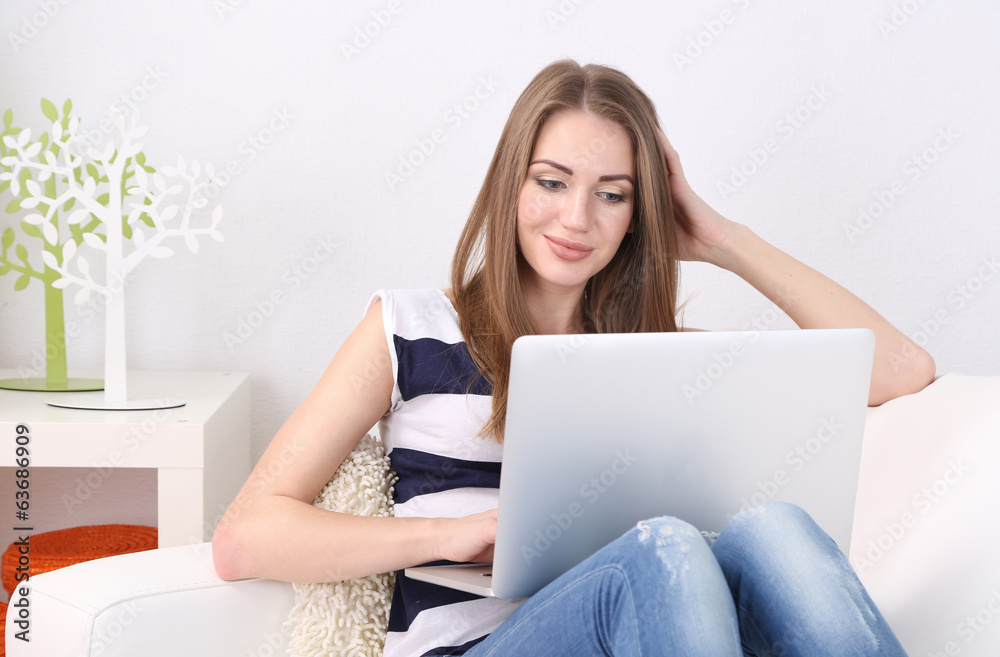 Young woman resting with laptop on sofa at home Young woman resting with laptop on sofa at home