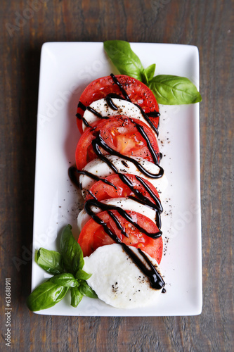 Картината върху платно Caprese salad with mozarella cheese, tomatoes and basil