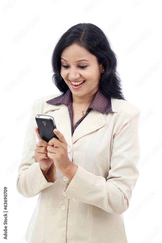 Young Indian business woman text messaging Young Indian business woman text messaging