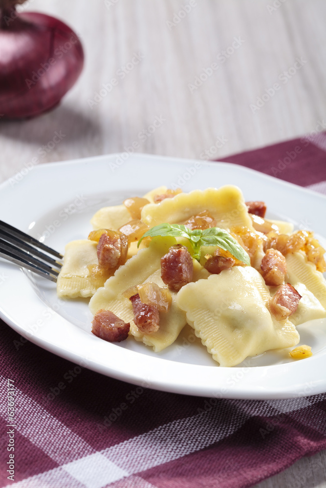 Portion of ravioli with onion and bacon Portion of ravioli with onion and bacon