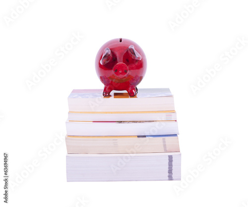 Red piggy bank on books