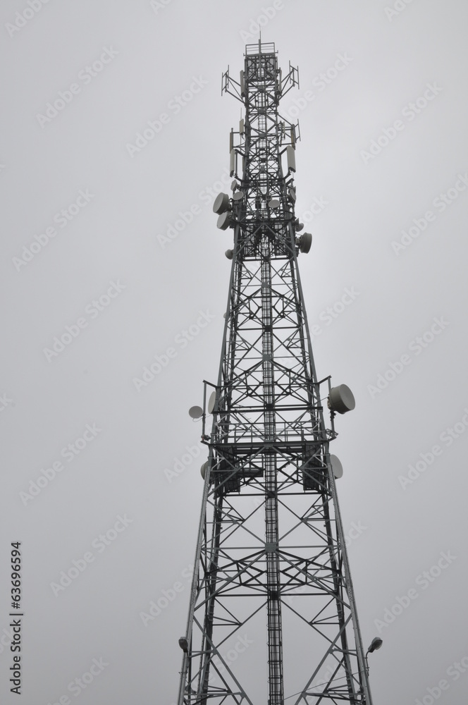 Telecommunication tower with antennas in the mist Telecommunication tower with antennas in the mist