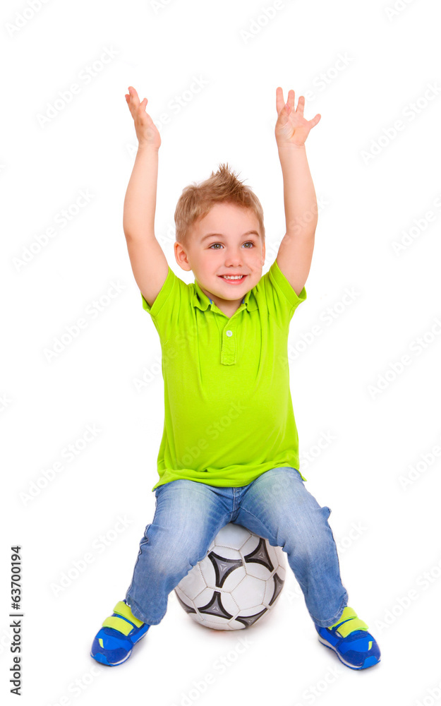 Happy little boy sitting on soccer ball Happy little boy sitting on soccer ball