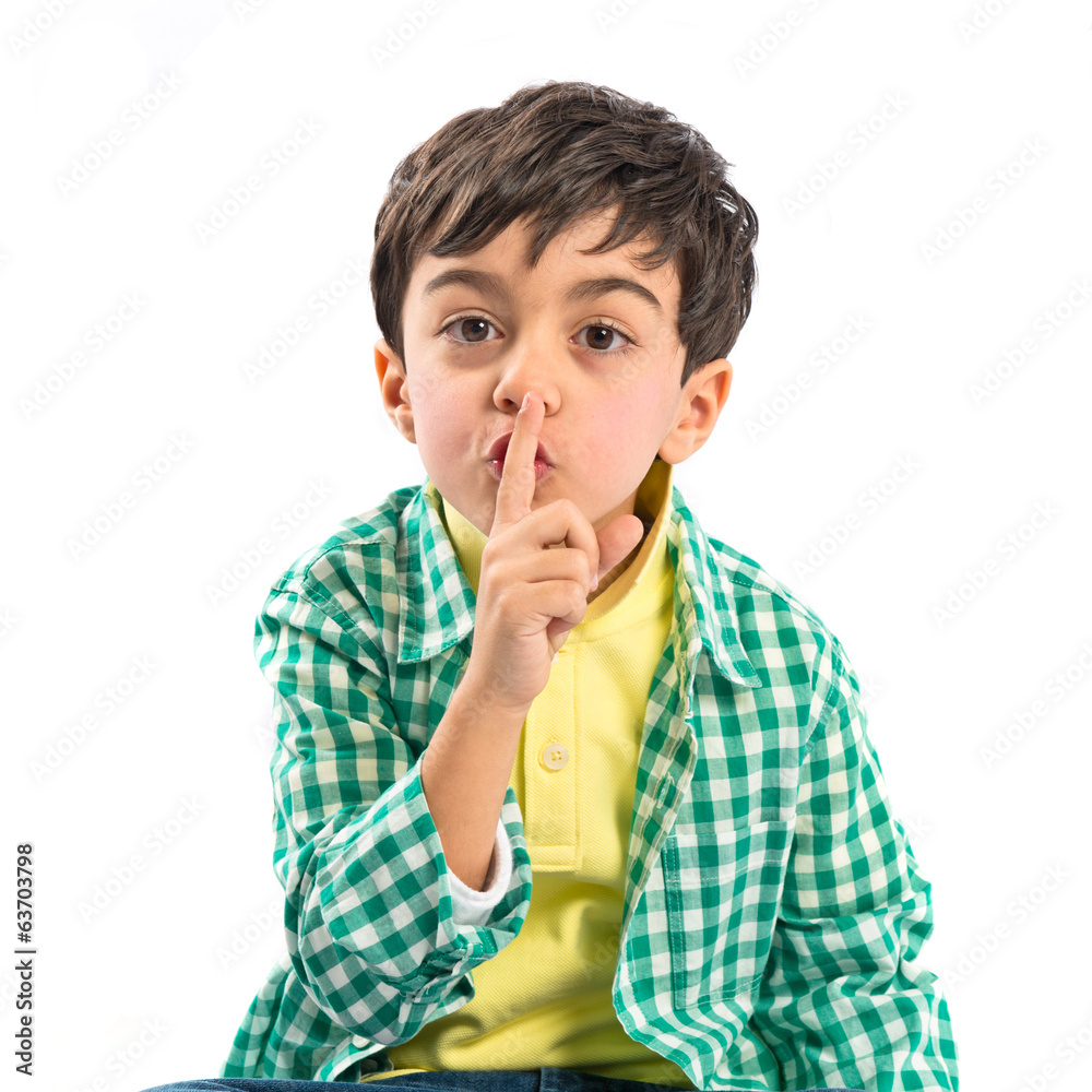Kid doing silence gesture over white background Kid doing silence gesture over white background