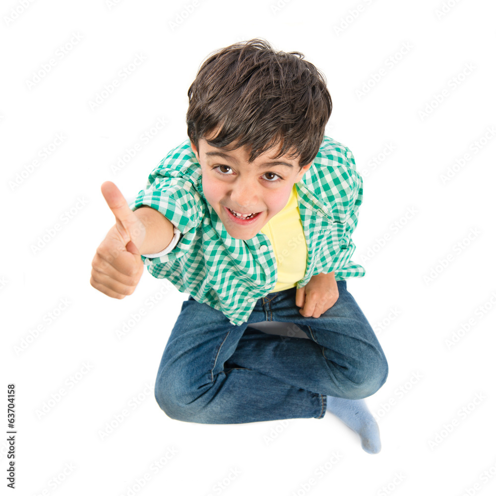 Cute kid making victory gesture over white background Cute kid making victory gesture over white background