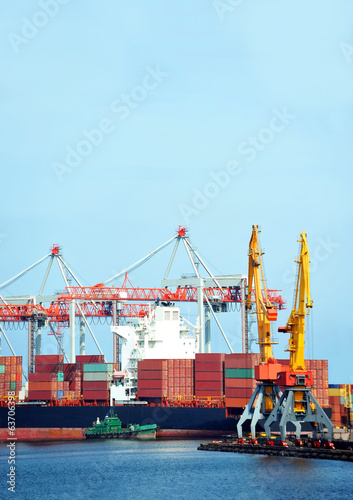 Container stack and ship under crane bridge