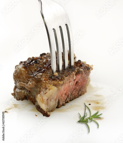 Piece Of Red  Meat Steak On A Fork photo