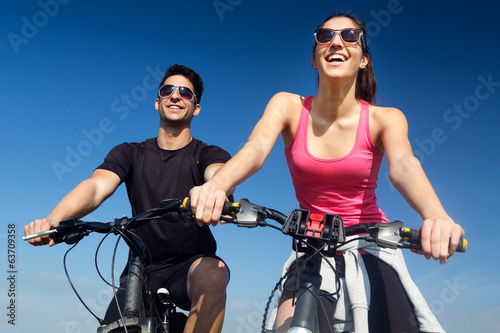 Happy young  couple on a bike ride in the countryside © nenetus