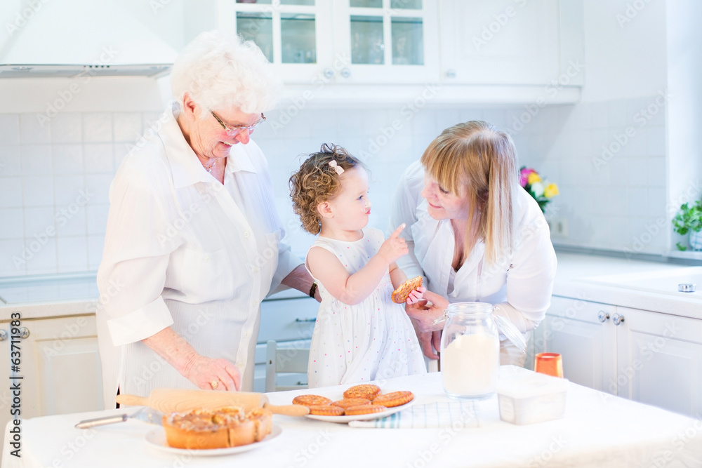 Happy funny toddler girl playing in a white beautiful kitchen Happy funny toddler girl playing in a white beautiful kitchen