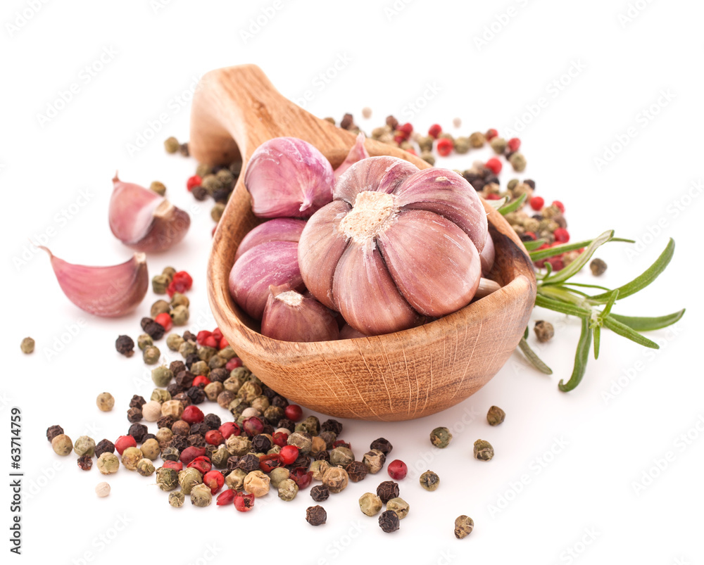 Garlic cloves in wooden bowl isolated on white background Garlic cloves in wooden bowl isolated on white background