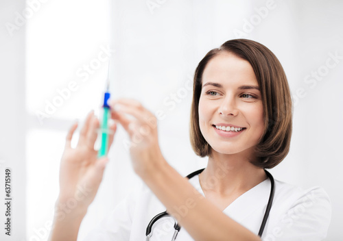 female doctor holding syringe with injection