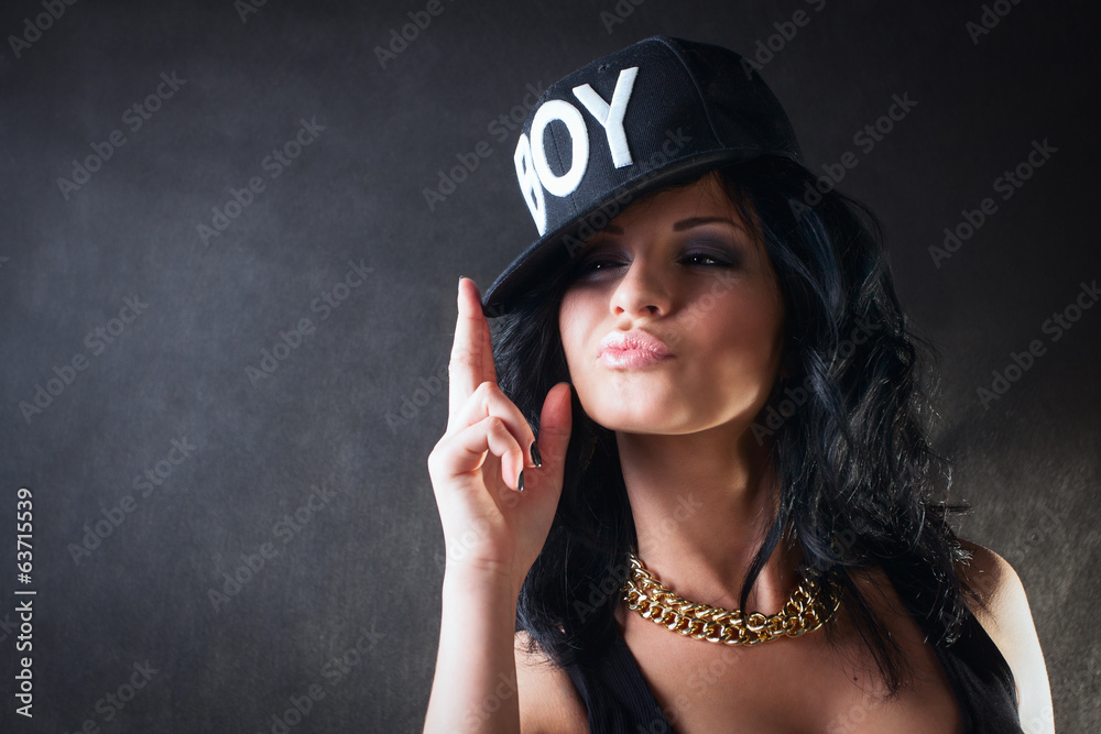 Cool brunette in cap. Swag girl Photos | Adobe Stock