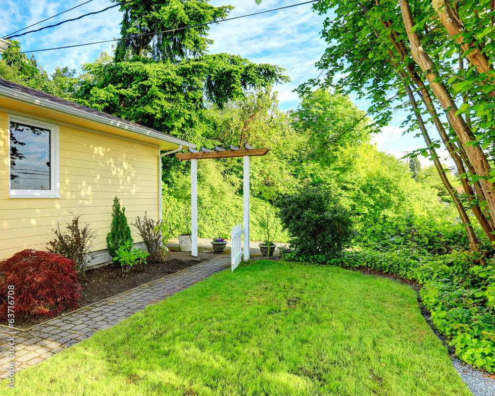 Naklejka premium House with walkway and open gate
