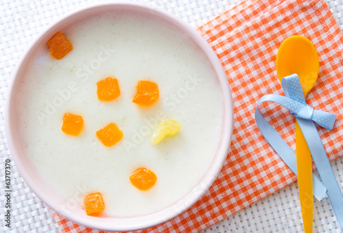 Baby food.Milk porridge with fruits. photo