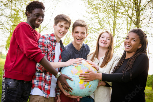 Multiracial Teen Couple Holding Globe Map