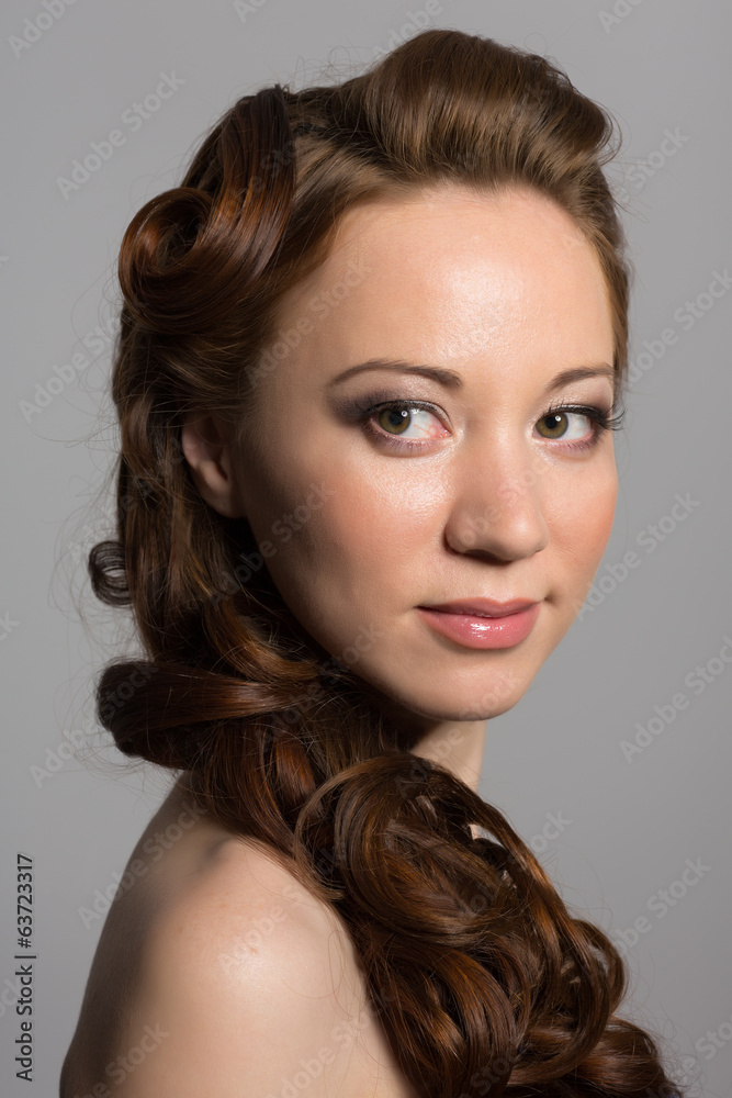 Beautiful girl on a gray background looking away Beautiful girl on a gray background looking away
