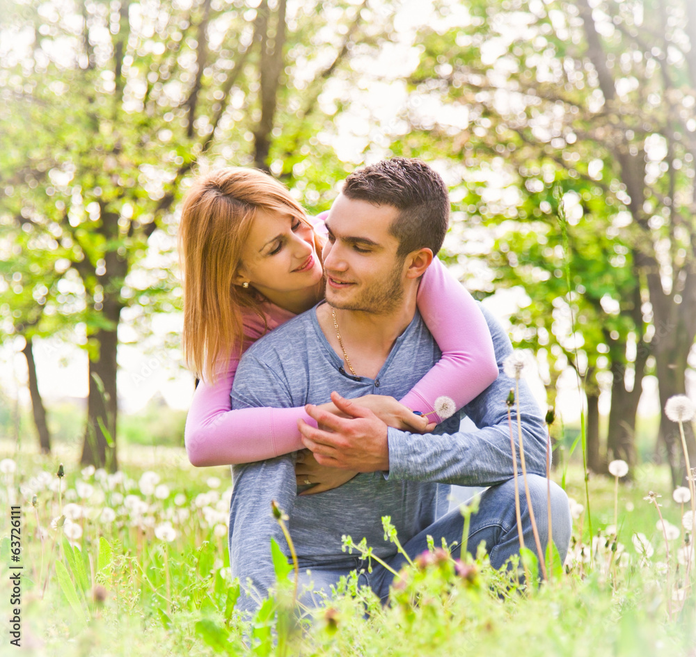 Happy couple embracing outdoor in park. Happy couple embracing outdoor in park.