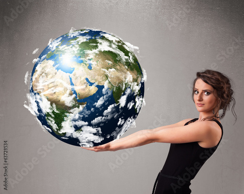 Pretty girl holding 3d planet earth photo